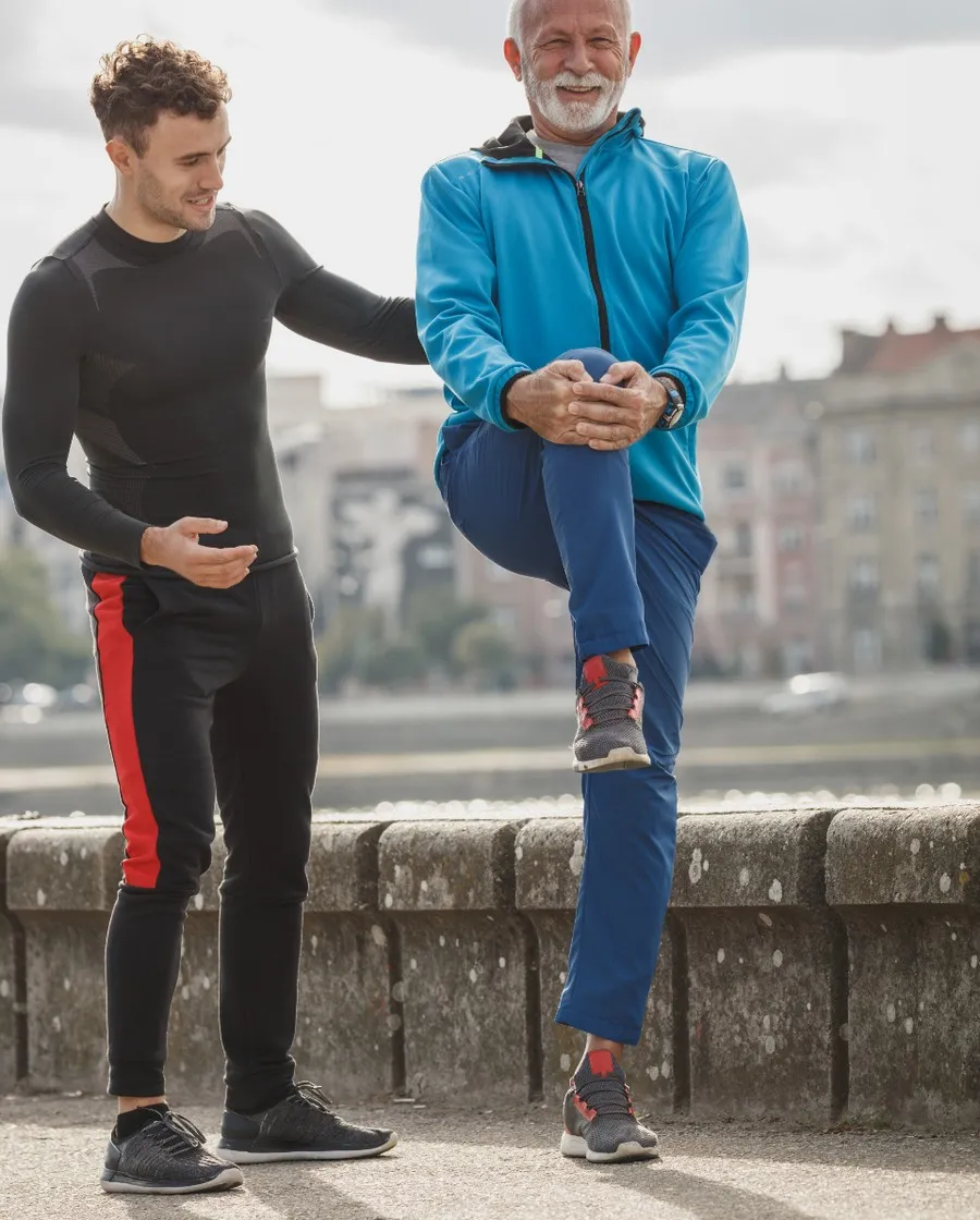 Physiotherapist guiding a patient through a supported leg stretch at Megazee.com Physiotherapy