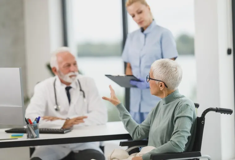 Clinician reviewing a post-operative rehabilitation plan with an older patient